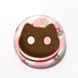 A cute drawing by Camie M. Anderson of a Cookie Cat ice cream sandwhich from Steven Universe on a handmade button