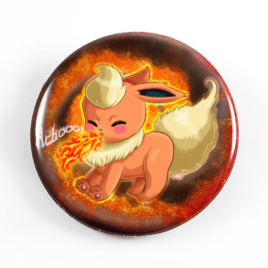 A cute chibi drawing by Camie M. Anderson of Flareon from Pokemon on a handmade button