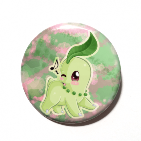 A cute chibi version of Chikorita from Pokemon drawn by Camie M. Anderson on a handmade button.