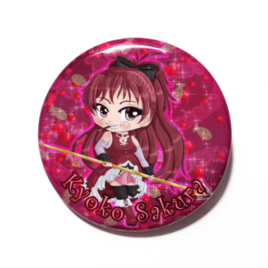 A cute chibi version of Kyoko Sakura from Puella Magi Madoka Magica drawn by Camie M. Anderson on a handmade button