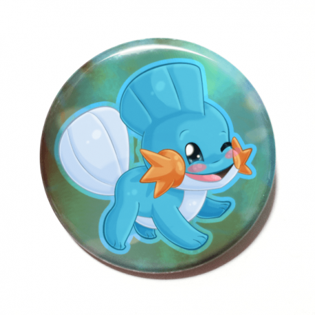 A cute chibi version of Mudkip from Pokemon drawn by Camie M. Anderson on a handmade button