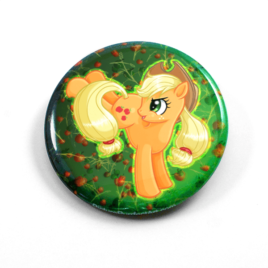 A cute chibi drawing by Camie M. Anderson of Applejack from My Little Pony on a handcrafted button