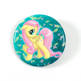A cute chibi drawing by Camie M. Anderson of Fluttershy from My Little Pony on a handcrafted button