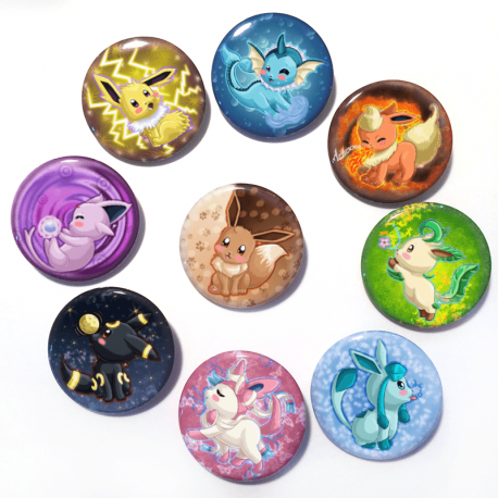 A set of nine handmade buttons of Eevee and all it's evolutions (aka eeveelutions) drawn by Camie M. Anderson