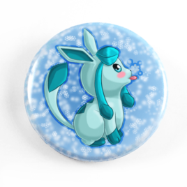 A cute chibi drawing by Camie M. Anderson of Glaceon from Pokemon on a handmade button