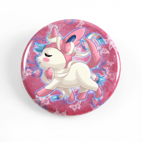 A cute chibi drawing by Camie M. Anderson of Sylveon from Pokemon on a handmade button