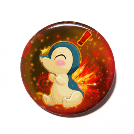 A cute chibi version of Cyndaquil from Pokemon drawn by Camie M. Anderson on a handmade button.