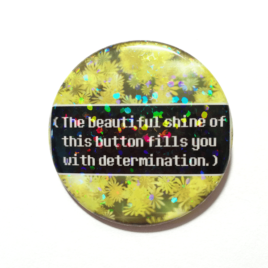 A clever saying about determination on a button made by Camie M. Anderson