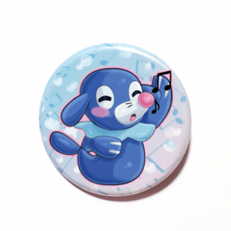 A cute chibi version of Popplio from Pokemon drawn by Camie M. Anderson on a handmade button