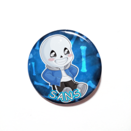 A cute chibi drawing of Sans on a inique handmade button by Camie m. Anderson