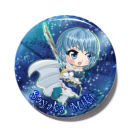 A cute chibi version of Sayaka Miki from Puella Magi Madoka Magica drawn by Camie M. Anderson on a handmade button